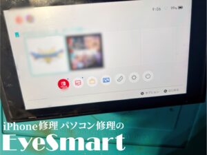 Nintendo Switchのホーム画面。ゲームカードスロットの交換が完了し、動作確認中です。画面にはゲームアイコンが表示されており、正常に動作していることが確認できます。画面下部には『iPhone修理パソコン修理のEyeSmart』のロゴが記載されています。